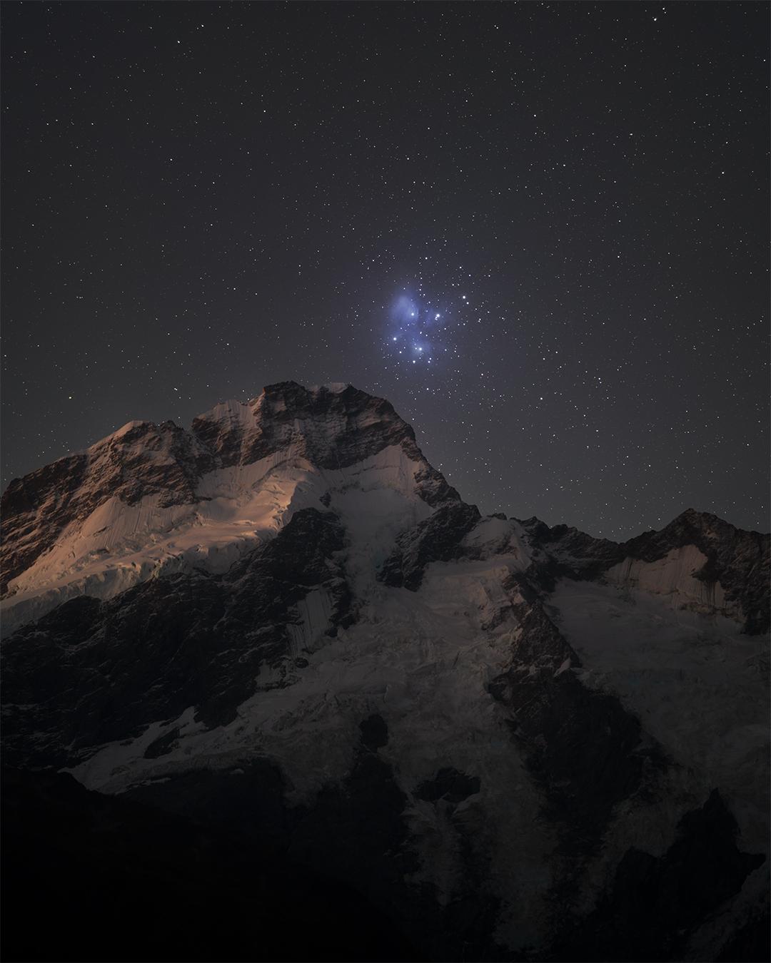 2025 November 1

Pleiades from Planet Earth
 * Image Credit & Copyright: Max Inwood

Explanation: 
The lovely Pleiades star cluster shines in Earth's night sky, a compact group of stars some 400 light-years distant toward the constellation Taurus and the Orion Arm of our Milky Way galaxy. Recognized since ancient times, the remarkable celestial gathering is visible to the unaided eye. The Pleiades cluster is also well-placed for viewing from both northern and southern hemispheres, and over the centuries has become connected to many cultural traditions and celebrations, including the cross-quarter day celebration Halloween. In Greek myth, the Pleiades were seven daughters of the astronomical titan Atlas and sea-nymph Pleione. Galileo first sketched the star cluster viewed through his telescope with stars too faint to be seen by eye and Charles Messier recorded the position of the cluster as the 45th entry in his well-known catalog of things which are not comets. In this dramatic night skyscape from planet Earth, the stars of the Pleiades appear embedded in dusty blue reflection nebulae, poised above Mt Sefton, one of the tallest peaks in New Zealand. There known as Matariki, the star cluster is associated with the celebration of the Maori new year. 

Authors & editors: Robert Nemiroff (MTU) & Jerry Bonnell (UMCP)
NASA Official: Amber Straughn Specific rights apply.
