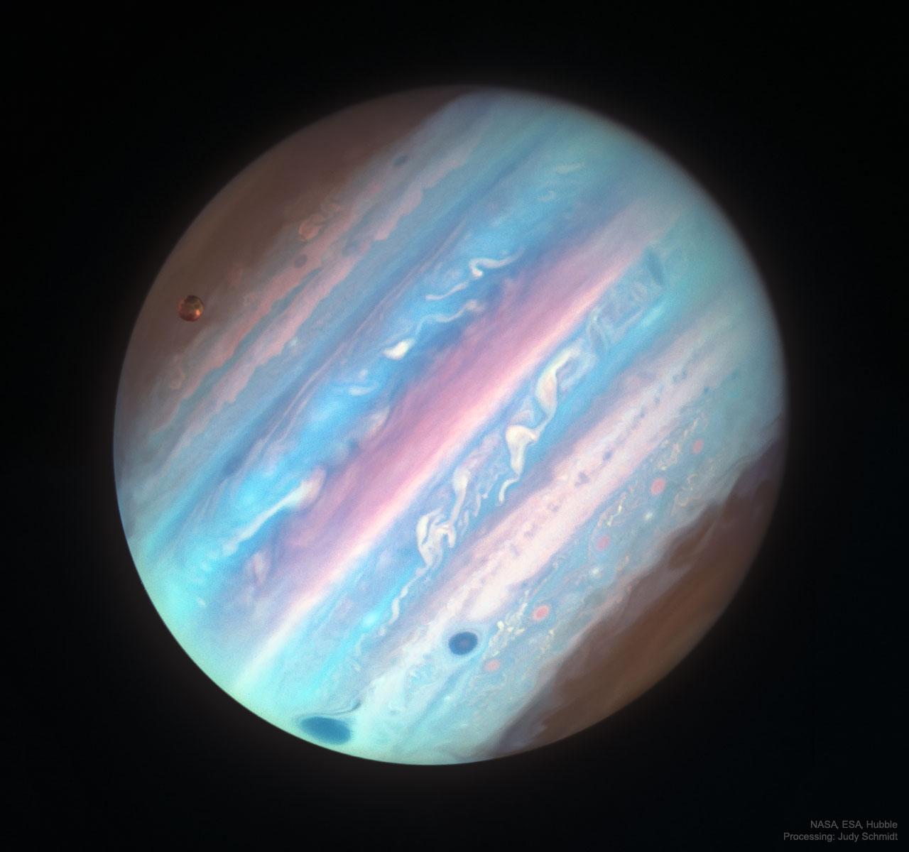 2025 November 11
The planet Jupiter appears full frame in apparent colors of a variety of blues and some pink bands. The Great Red Spot is visible on the lower left as a dark spot.

Jupiter in Ultraviolet from Hubble
 * Image Credit: NASA, ESA, Hubble; Processing & License: Judy Schmidt

Explanation:
 Jupiter looks a bit different in ultraviolet light. To better interpret Jupiter's cloud motions and to help NASA's robotic Juno spacecraft understand the planetary context of the small fields that it sees, the Hubble Space Telescope was being directed to regularly image the entire Jovian giant. The colors of Jupiter being monitored go beyond the normal human visual range to include both ultraviolet and (not pictured) infrared light. Featured from 2017, Jupiter appears different in near ultraviolet light, partly because the amount of sunlight reflected back is distinct, giving differing cloud heights and latitudes discrepant brightnesses. In the near UV, Jupiter's poles appear relatively dark, as does its Great Red Spot and a smaller (optically) white oval to the right. The String of Pearl storms farther to the right, however, are brightest in near ultraviolet, and so here appear (false-color) pink. Jupiter's largest moon Ganymede appears on the upper left. Juno continues on a looping 33-day orbit around Jupiter, while Earth-orbiting Hubble is aging and now relies on a single stabilizing gyroscope. 

Authors & editors: Robert Nemiroff (MTU) & Jerry Bonnell (UMCP)
